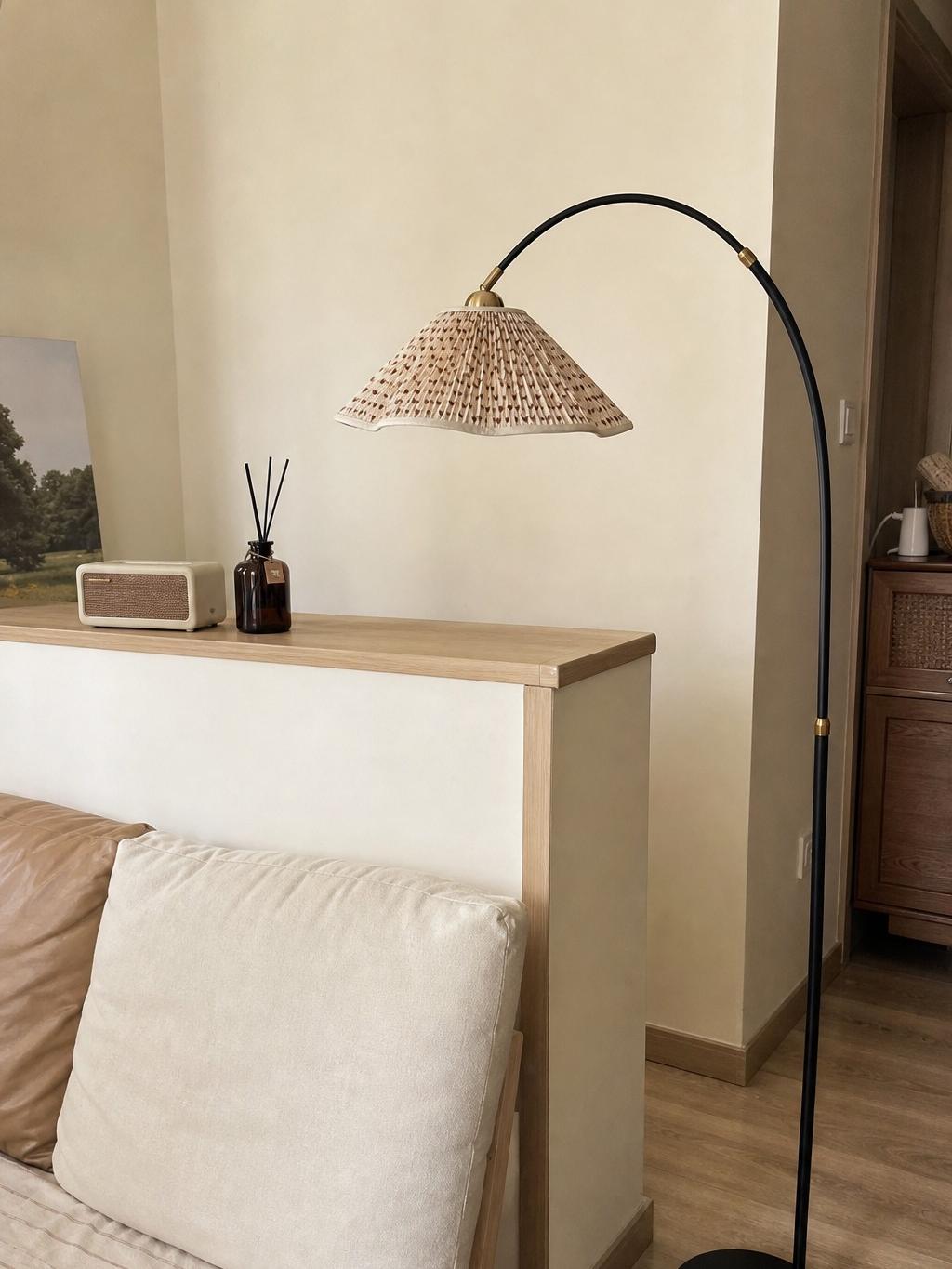 Gooseneck floral floor lamp beside sofa