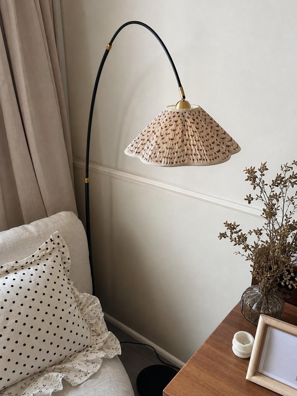 Floral shade floor lamp next to a cabinet