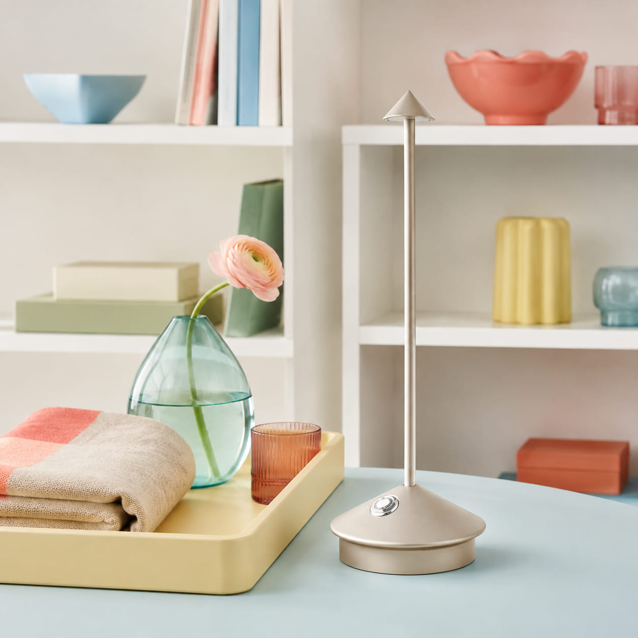 A hero product, supporting item and lamp form a simple display story.
