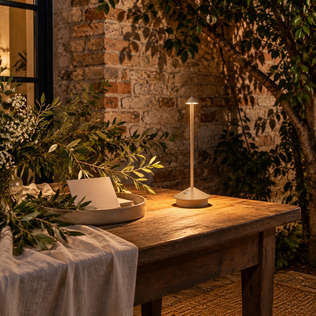 Wireless LED lamp creating a controlled pool of light on an outdoor wedding welcome table