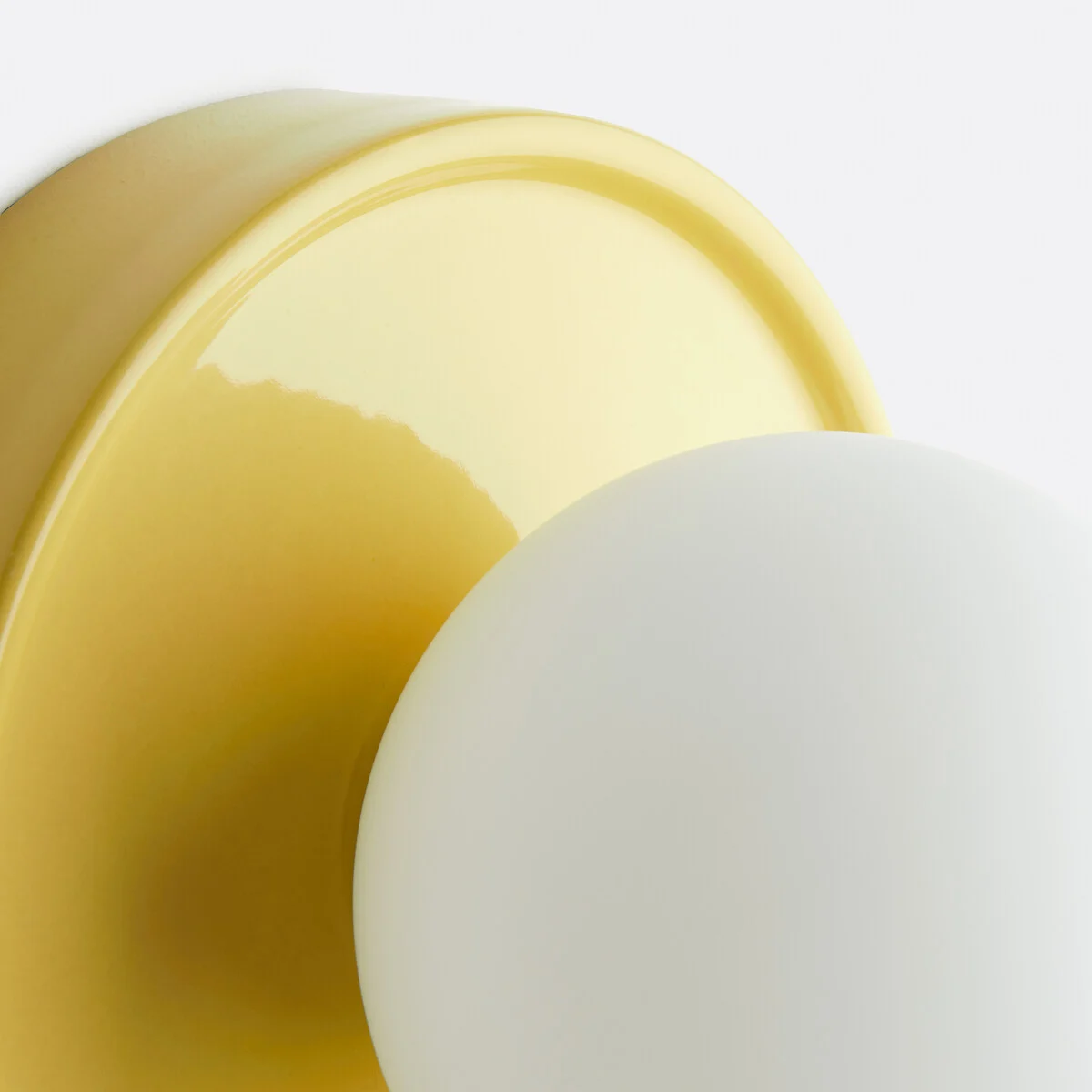 Close-up of the yellow ceramic base and glass globe