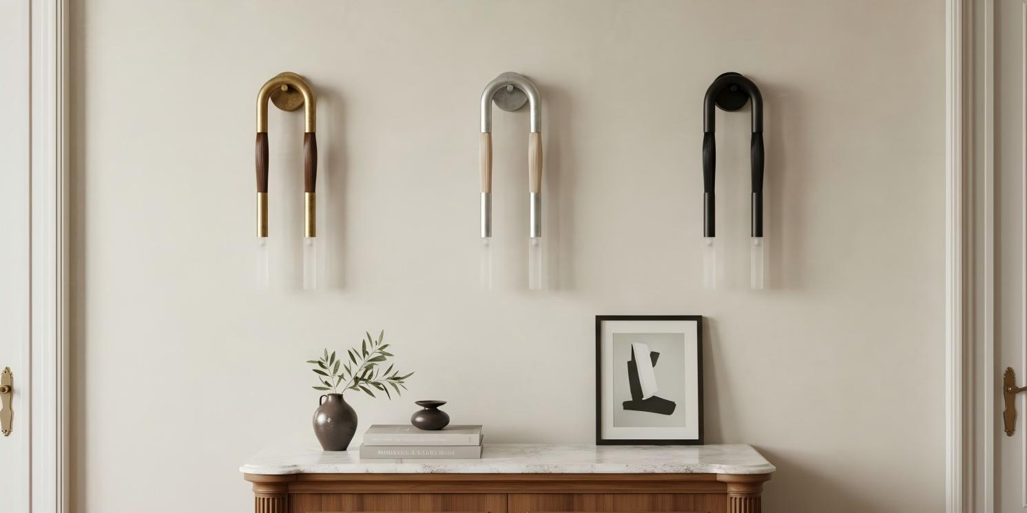 Strandia Double Heads Wall Sconce shown in three finishes above a console