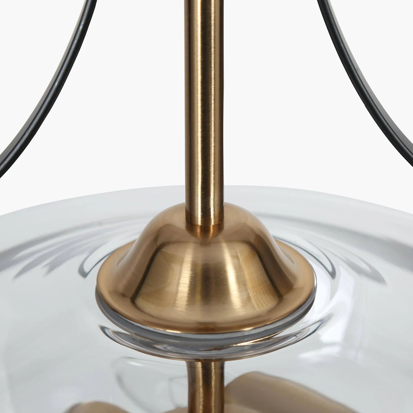 Close-up of Lirra pendant brass stem and clear glass