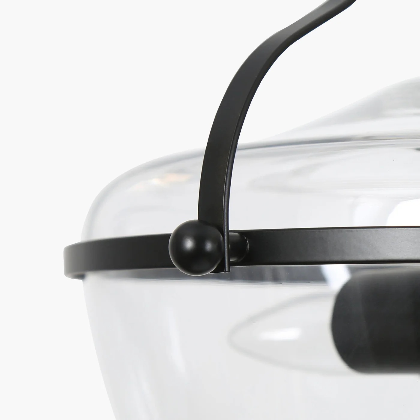 Close-up of Lirra pendant metal frame and glass shade