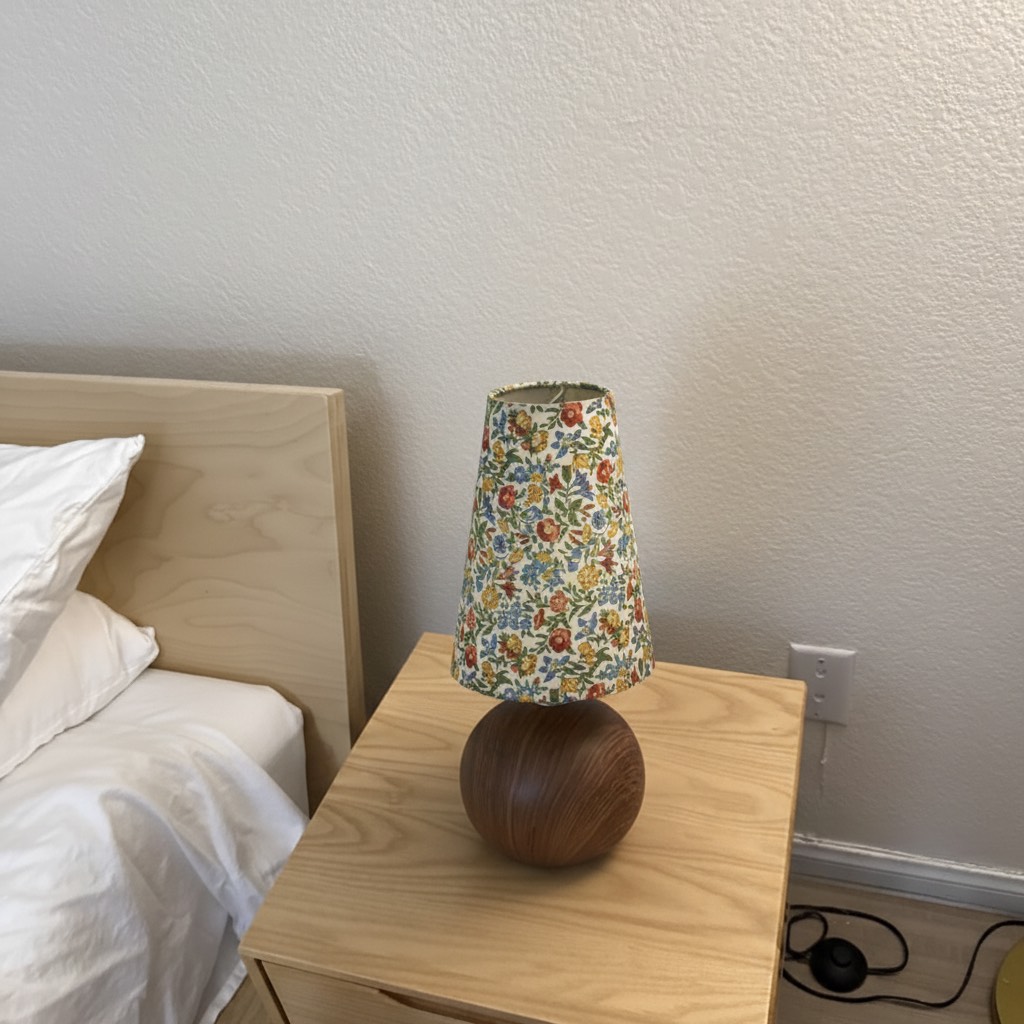 Customer styled Florence floral table lamp next to a bed