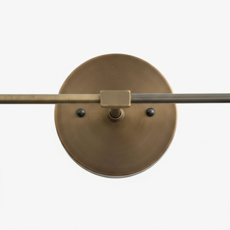 Close view of round wall plate and brass bar