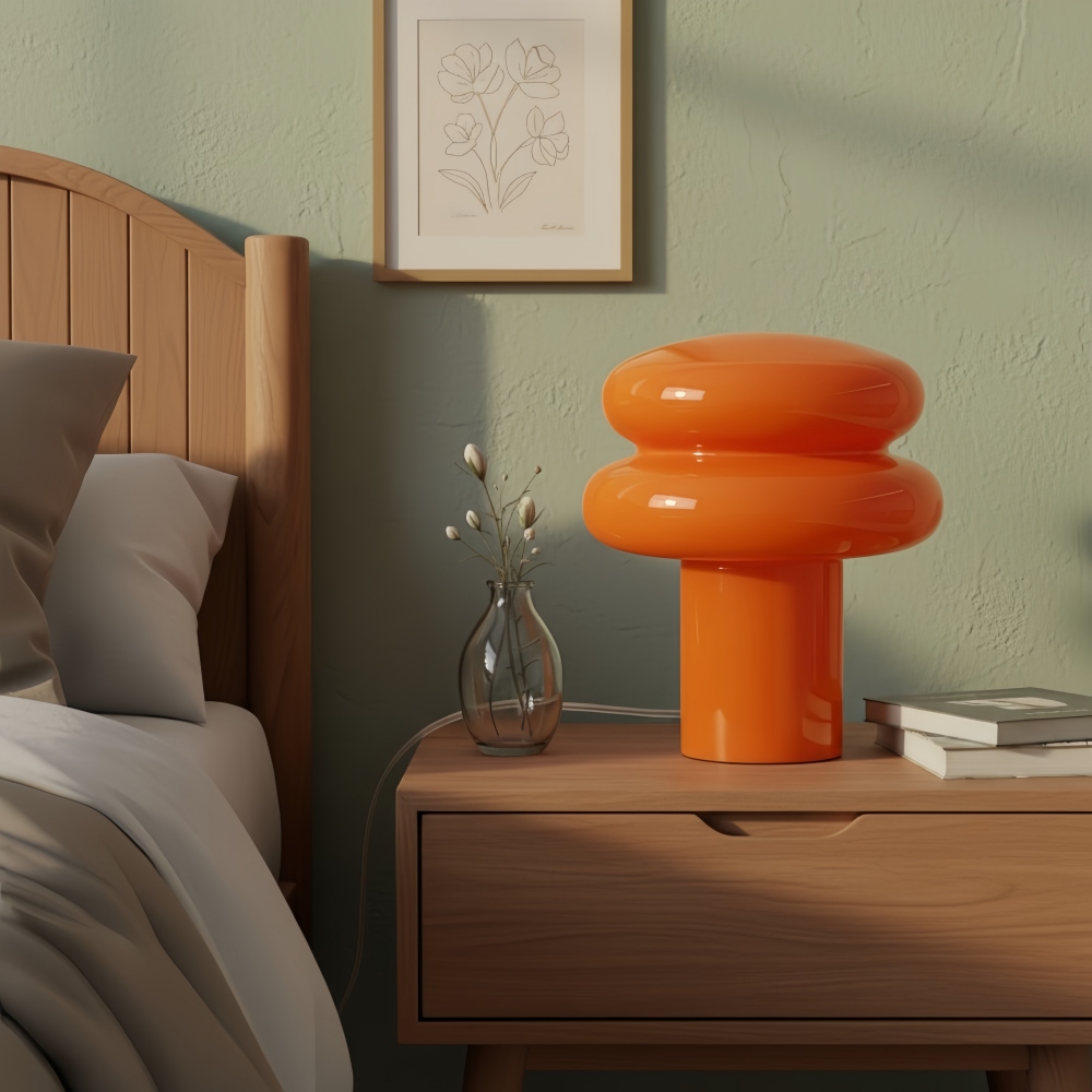 Orange opal table lamp beside a bed