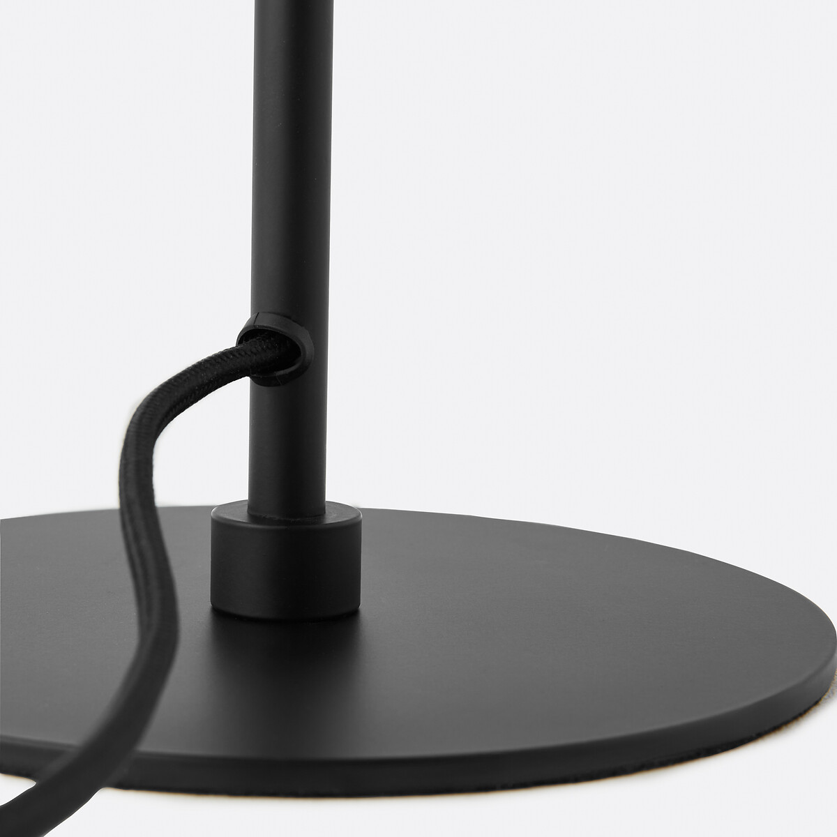 Close-up of the black iron lamp stem and base