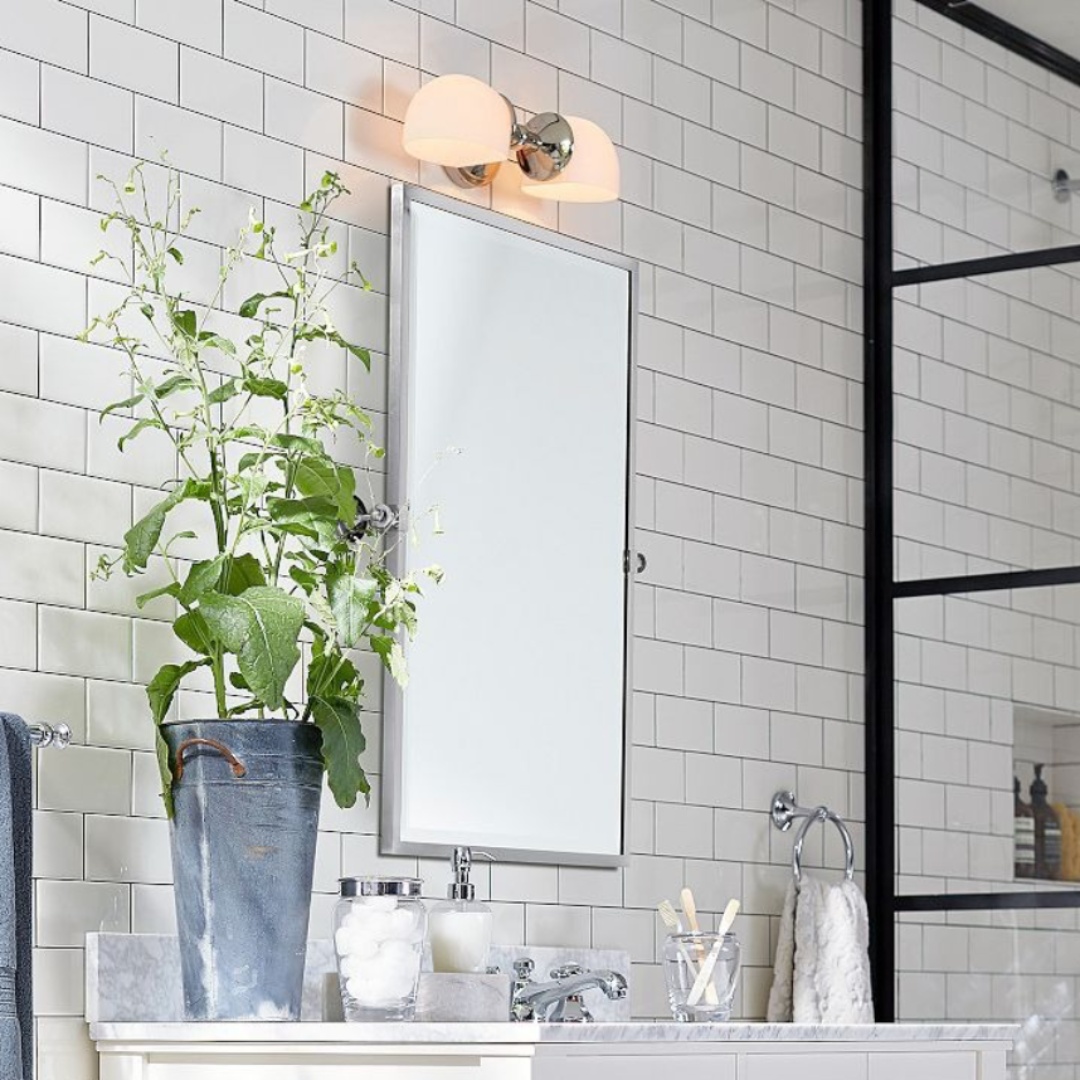 Modern Mercer Double Horizontal Metal Wall Sconce above a bathroom mirror