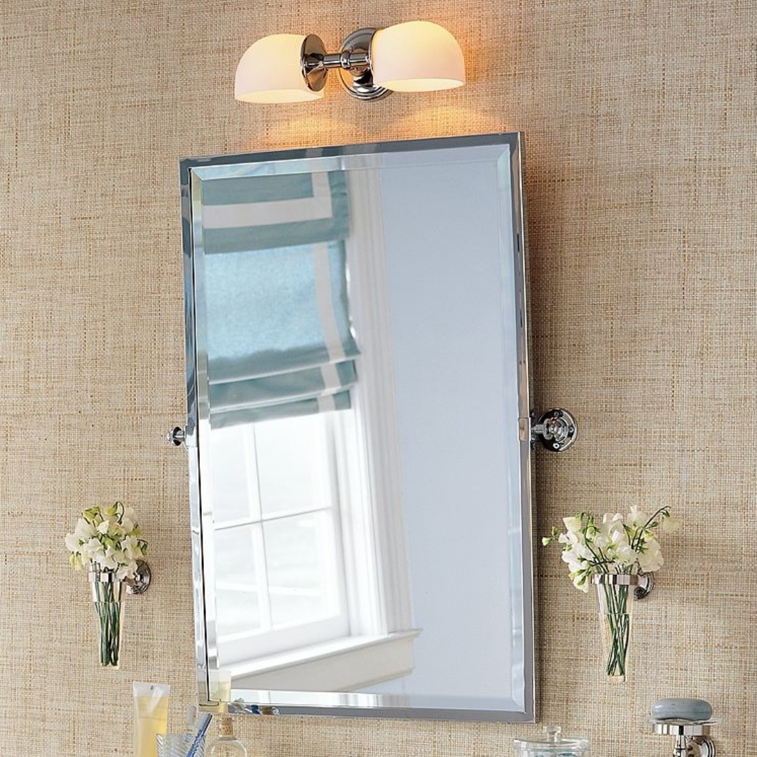 Mercer metal wall sconce lighting a bathroom vanity mirror