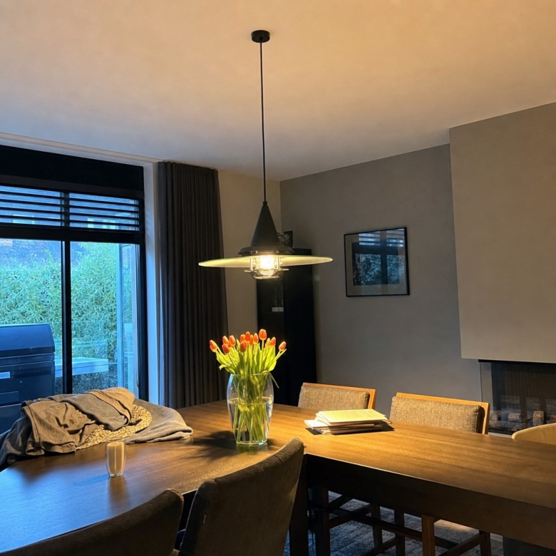 Customer room photo with Moxellan pendant light glowing over a dining table