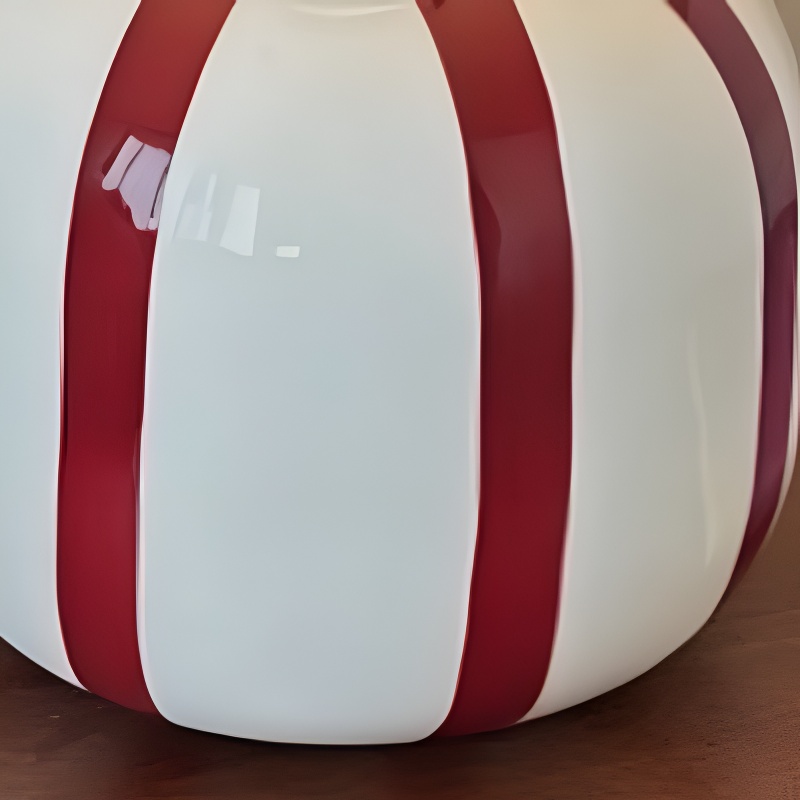 Close view of red and white ceramic lamp base