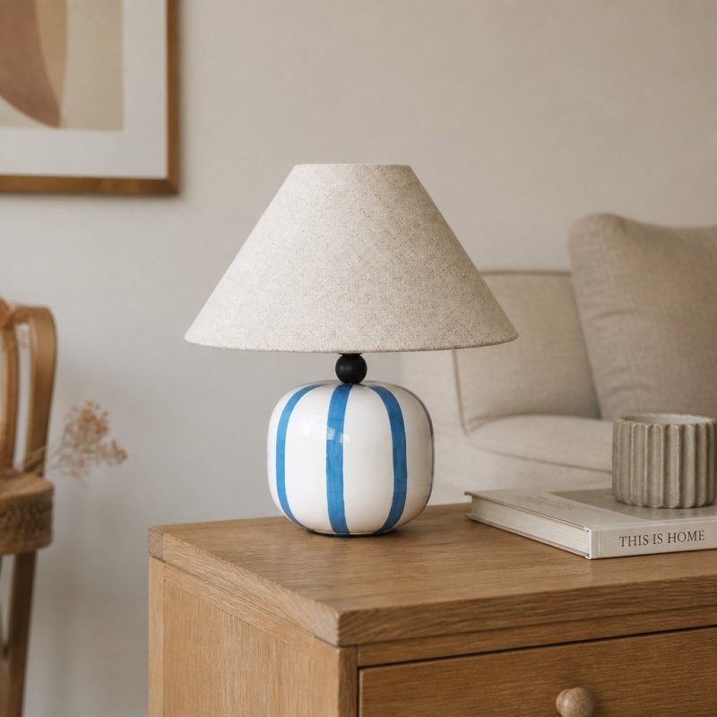 Ceruna table lamp beside books and decor