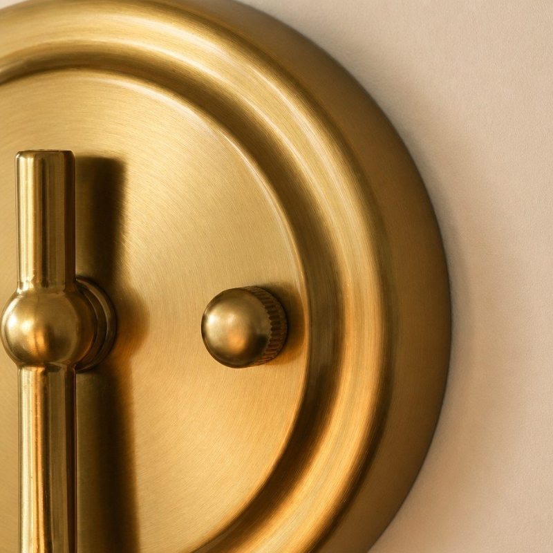 Close look at the brass wall plate and switch