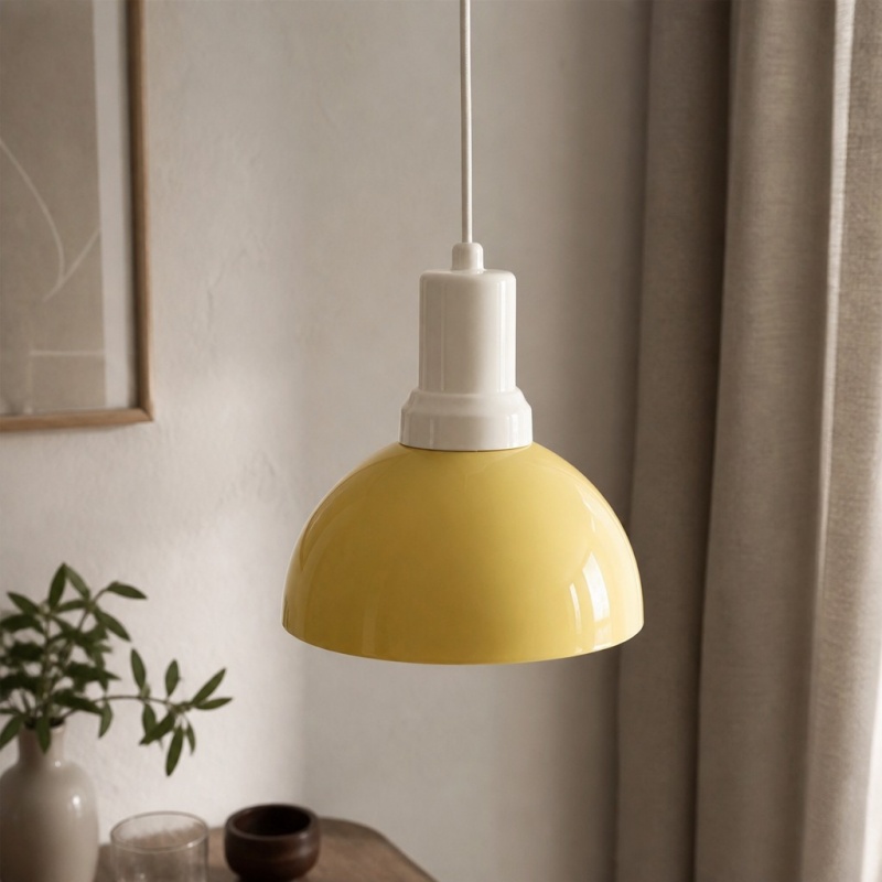 Rummia yellow pendant lamp beside curtains and greenery