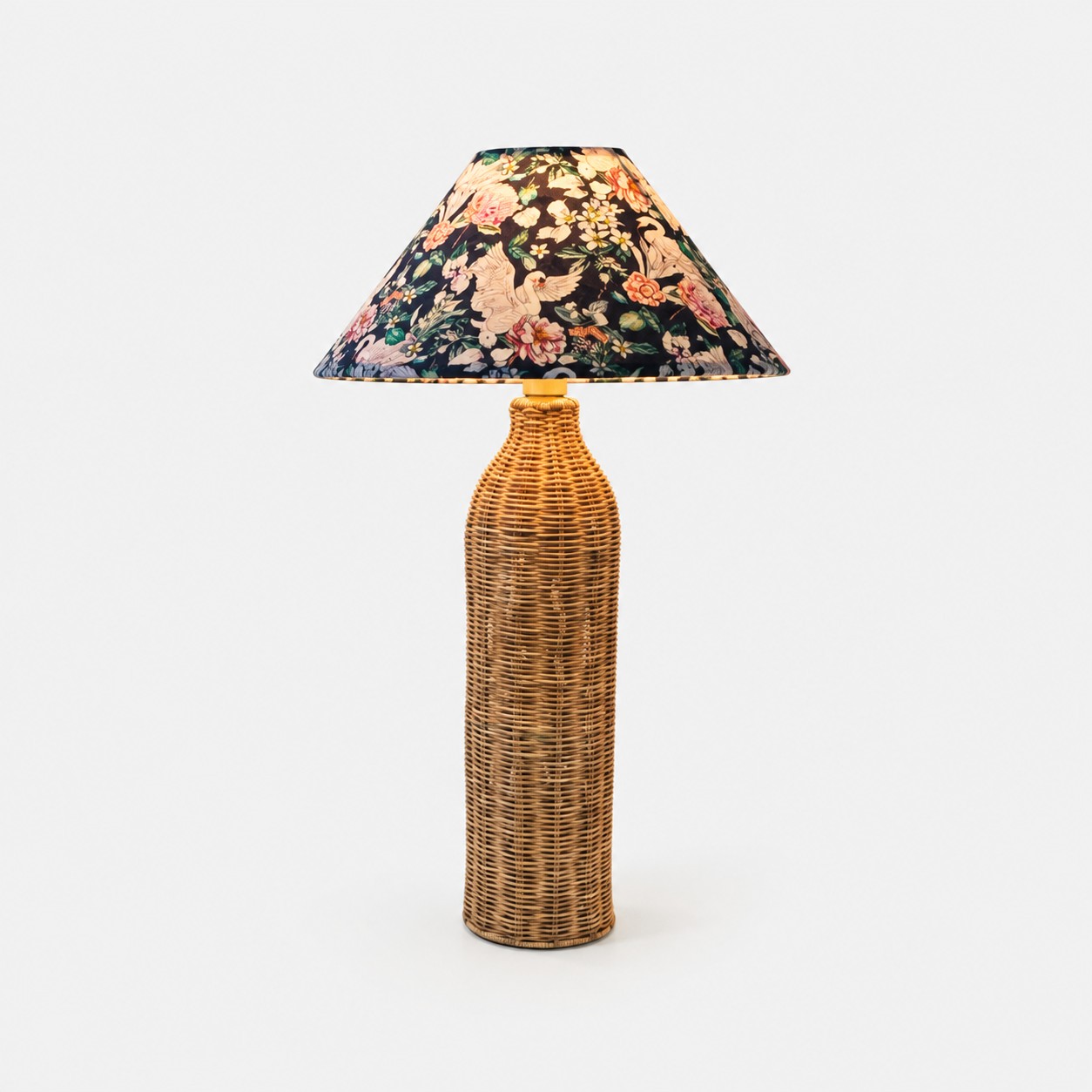 Woven rattan table lamp with botanical bird-print fabric shade
