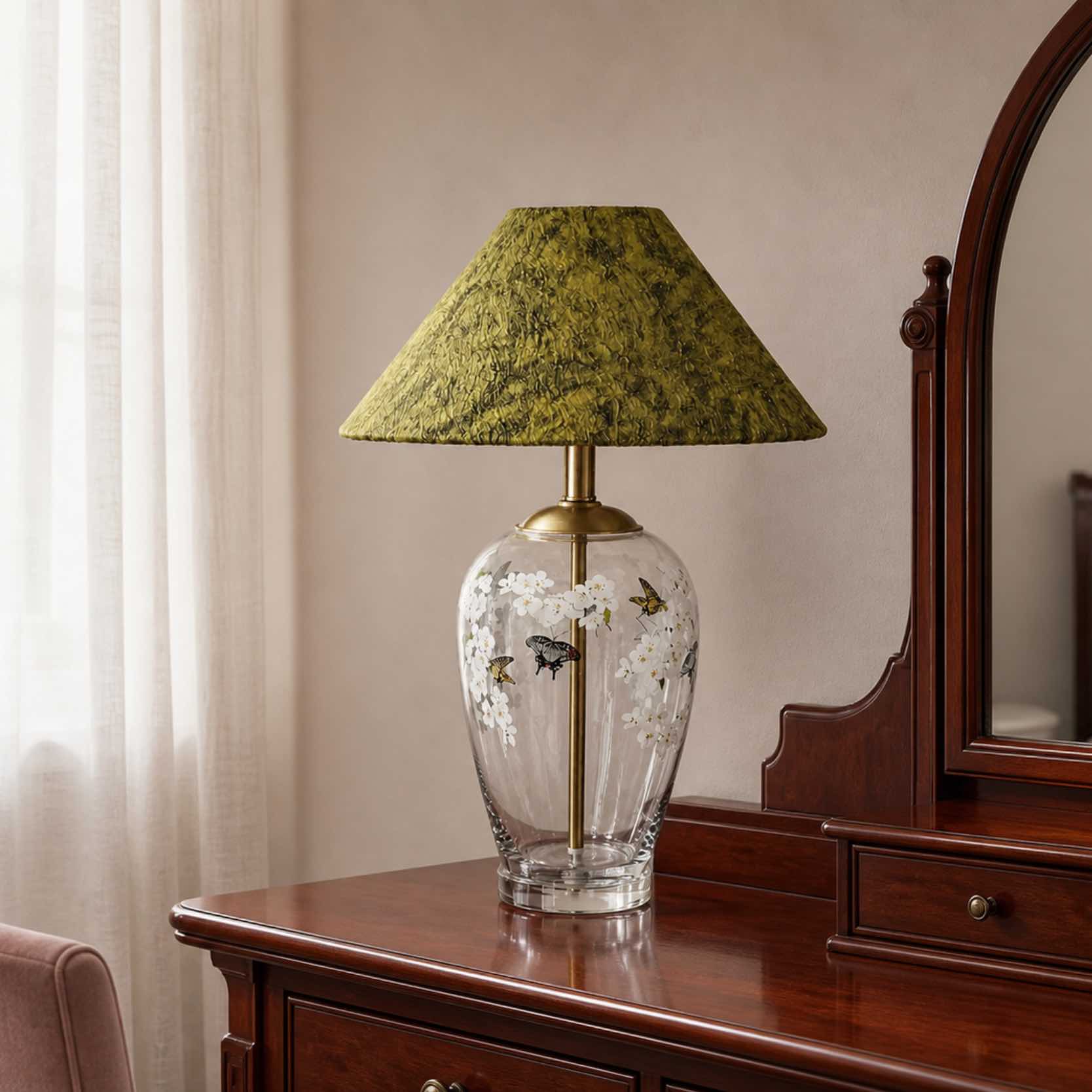 Floral glass table lamp on a vanity in diffuse morning light