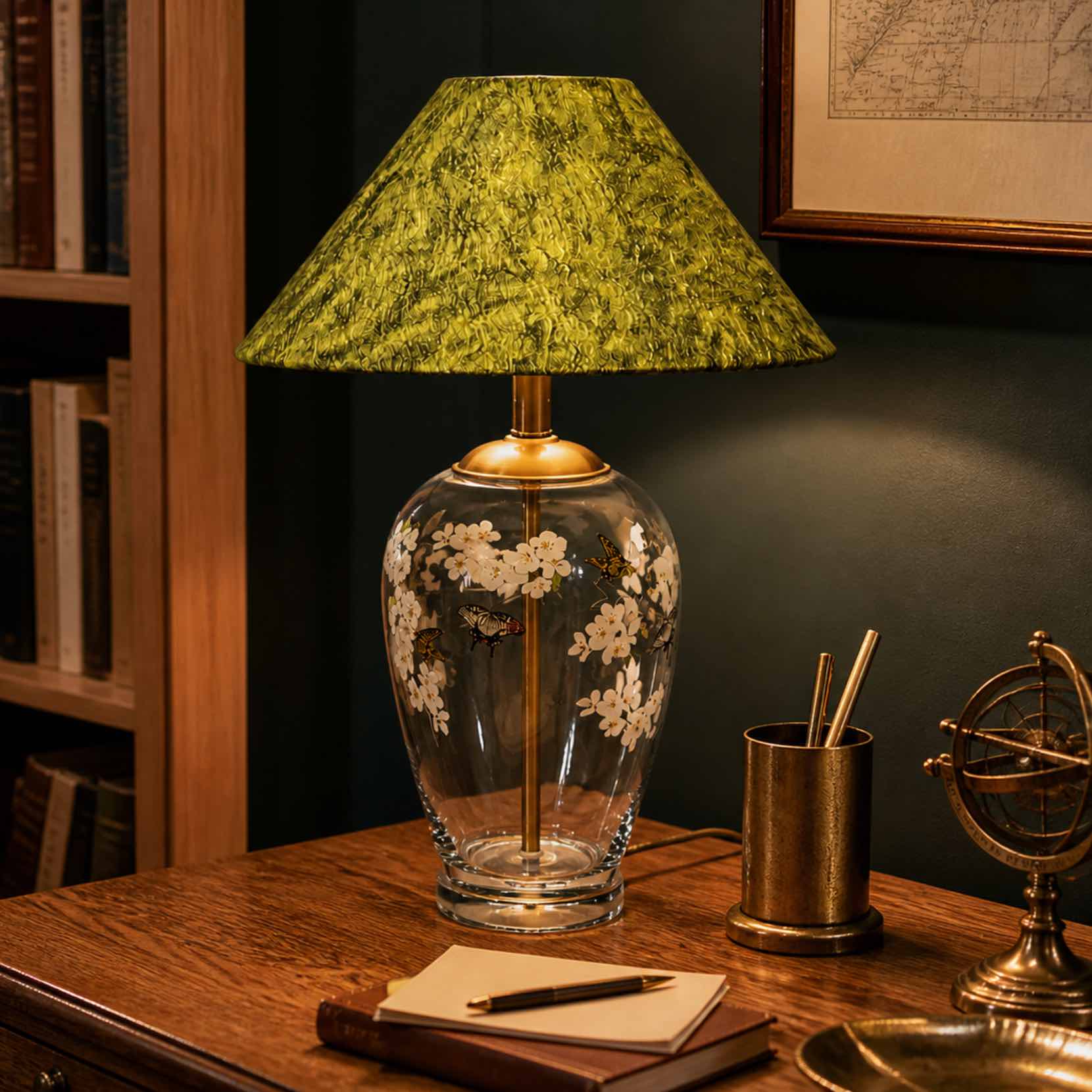 Floral glass table lamp glowing on a home study desk