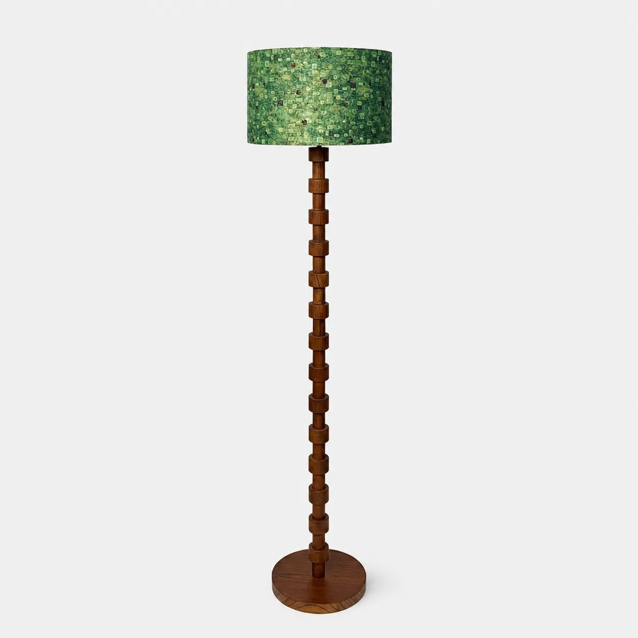 Full view of sculptural wood floor lamp with patterned fabric drum shade