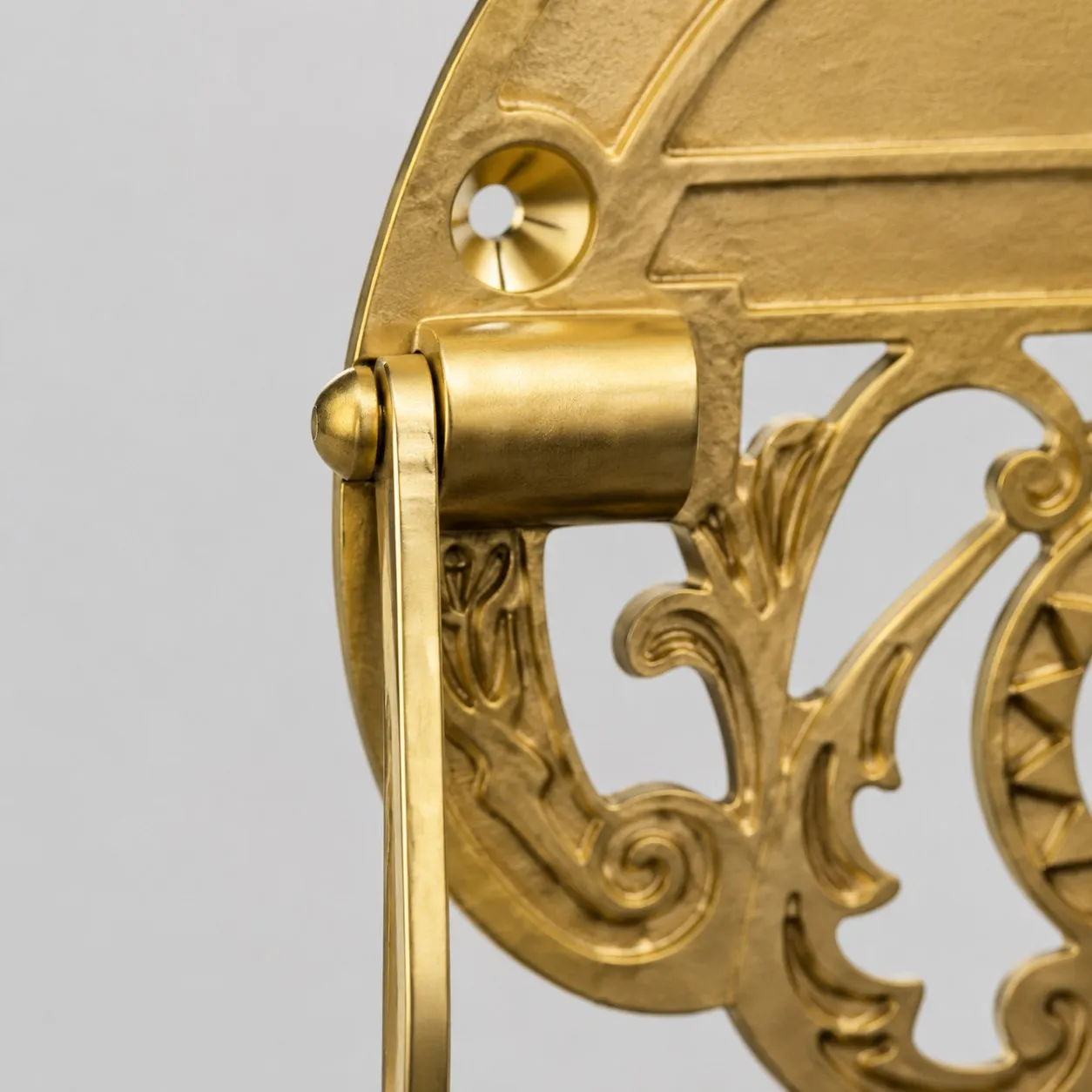 Close detail of brass side bracket and hinge