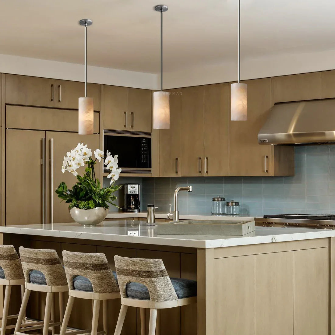 Alabaster cylinder pendant lights in a kitchen setting