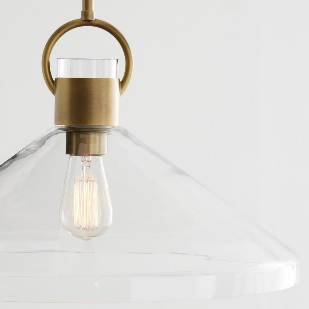Close-up of brass Orvessa pendant light shade and bulb
